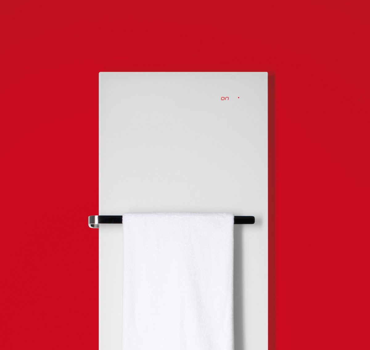 ELEMENTO vertical in Weiss matt mit Handtuchstange vor rotem Hintergrund